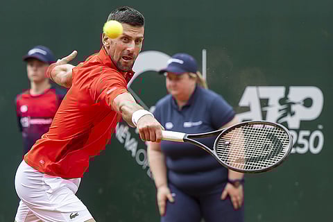 Novak Djokovic returns a ball to Tomas Machac